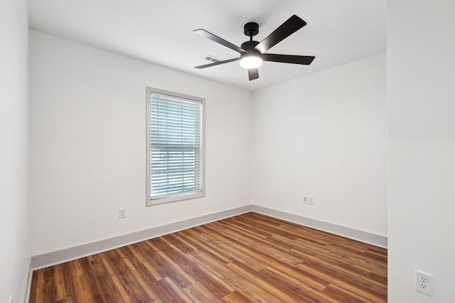 empty room with ceiling fan and hardwood / wood-style floors