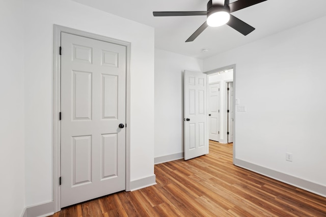 unfurnished bedroom with hardwood / wood-style flooring and ceiling fan