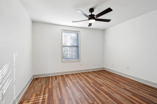 unfurnished room featuring ceiling fan and dark hardwood / wood-style flooring