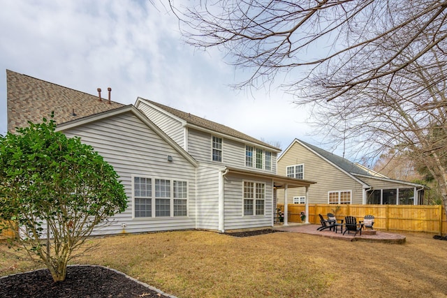 back of house with a yard, a fire pit, and a patio