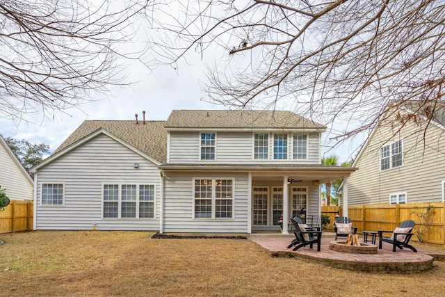 back of property featuring a patio, a lawn, and a fire pit