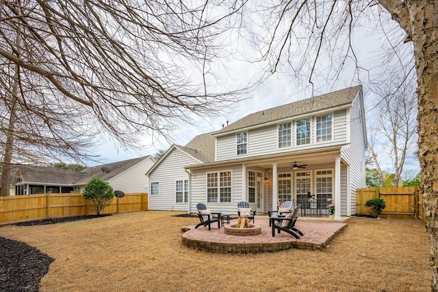 back of property with a patio, ceiling fan, and an outdoor fire pit