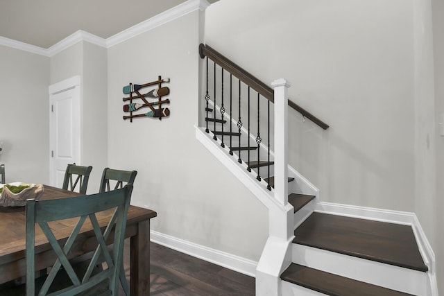 stairs with ornamental molding, wood finished floors, and baseboards