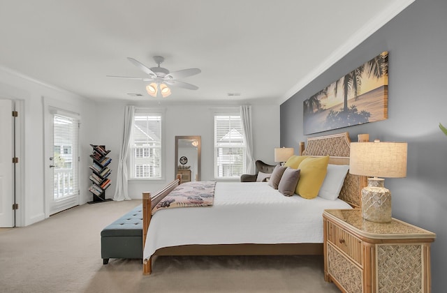 bedroom with carpet floors, access to outside, visible vents, and ceiling fan