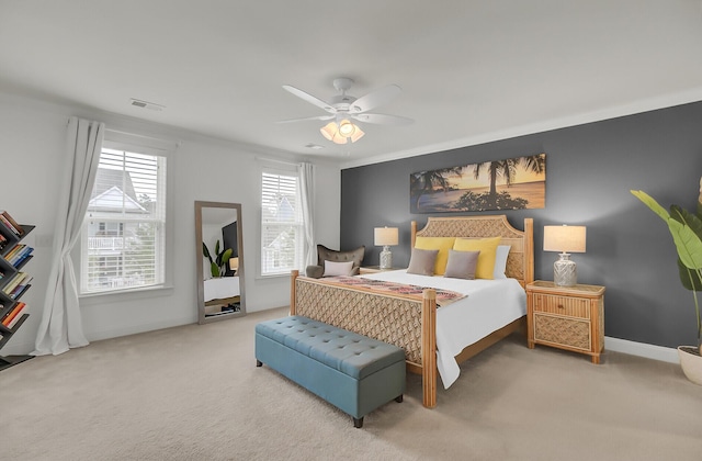 carpeted bedroom with ceiling fan, visible vents, and baseboards