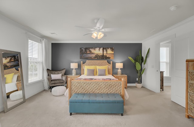 carpeted bedroom featuring ornamental molding, visible vents, and a ceiling fan