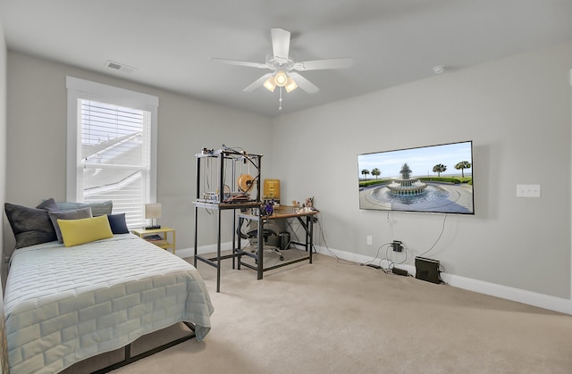 carpeted bedroom featuring a ceiling fan, visible vents, and baseboards