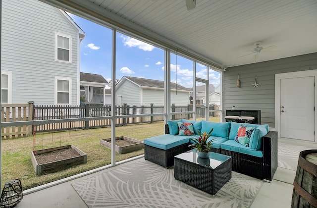 sunroom / solarium with a healthy amount of sunlight and ceiling fan