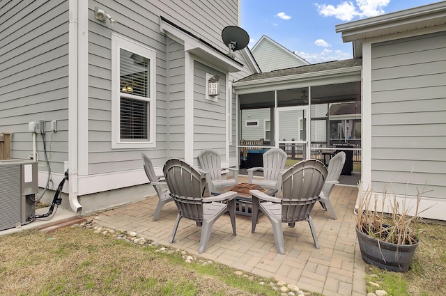 view of patio / terrace with a sunroom and central AC