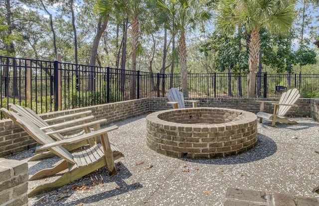 view of patio / terrace featuring an outdoor fire pit and a fenced backyard