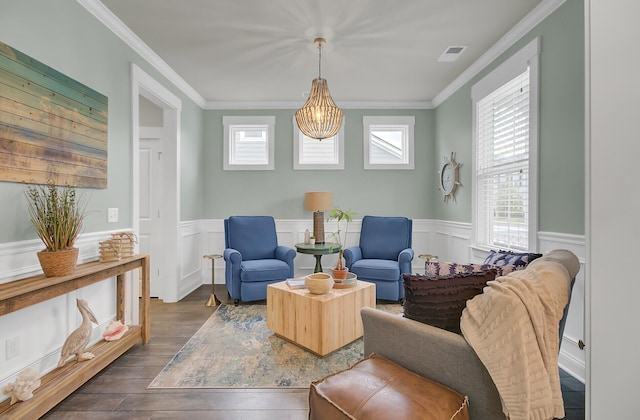 sitting room featuring dark wood-style floors, a healthy amount of sunlight, and crown molding