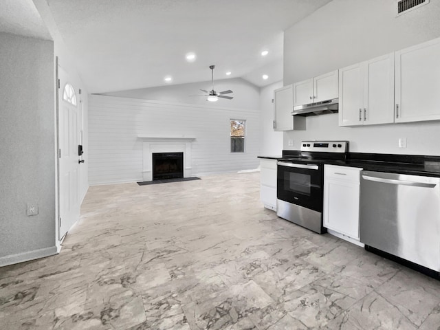 kitchen with vaulted ceiling, stainless steel appliances, white cabinetry, and ceiling fan