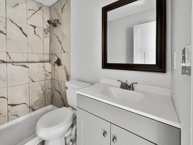 bathroom with vanity, toilet, and tiled shower