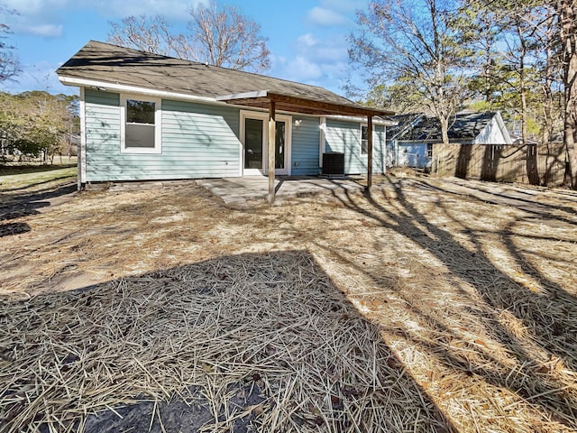 back of property with cooling unit and a patio