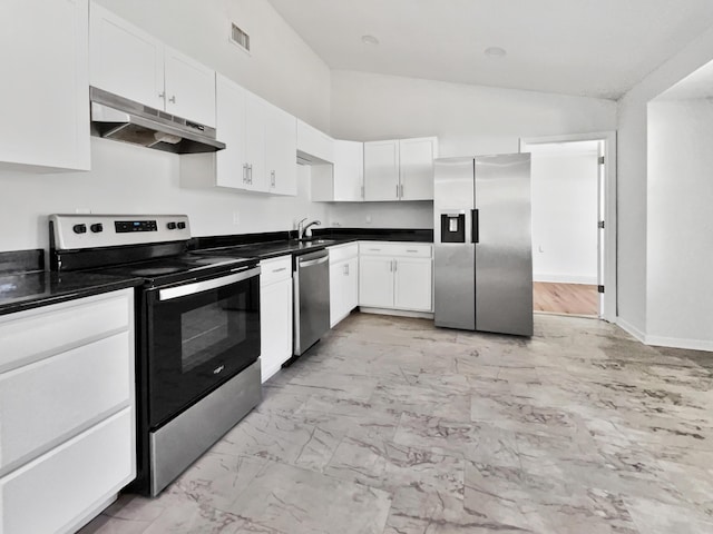 kitchen with sink, white cabinets, stainless steel appliances, and vaulted ceiling