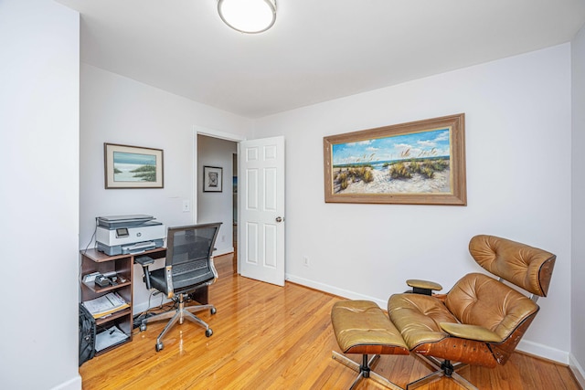 office with light wood-type flooring and baseboards