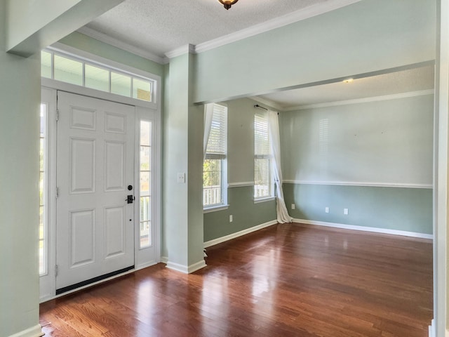 entryway featuring a textured ceiling, dark hardwood / wood-style flooring, and crown molding