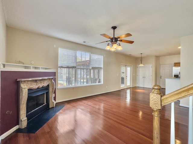 unfurnished living room with hardwood / wood-style floors and ceiling fan