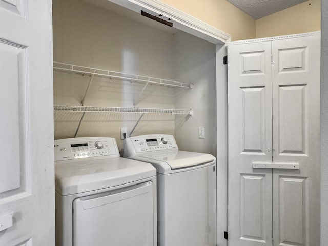 clothes washing area featuring washer and clothes dryer