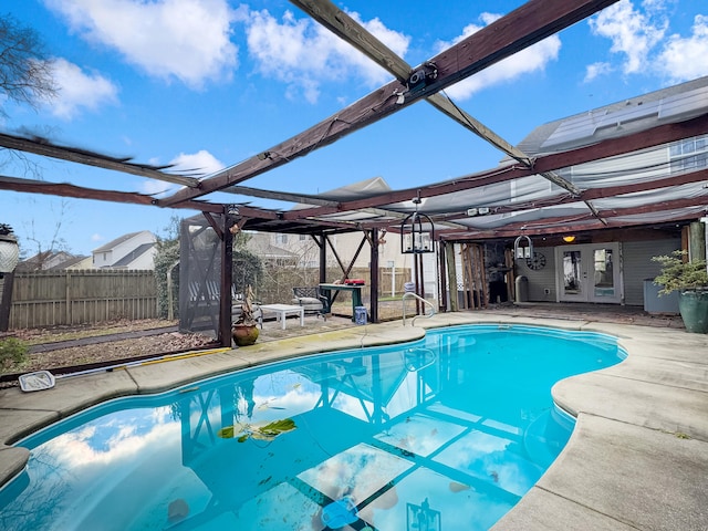 view of swimming pool with a lanai, french doors, and a patio