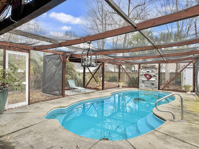 view of swimming pool featuring a patio area and glass enclosure