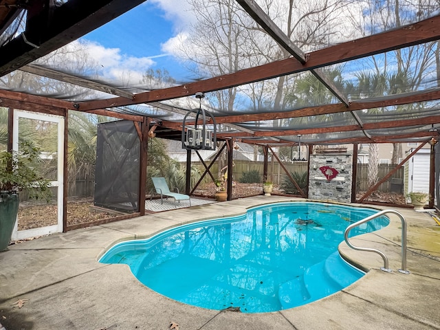 view of pool featuring a patio area and glass enclosure