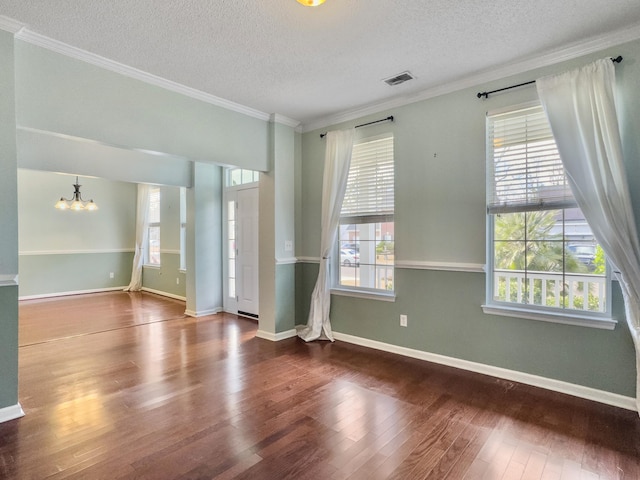 unfurnished room with a wealth of natural light, a chandelier, and ornamental molding