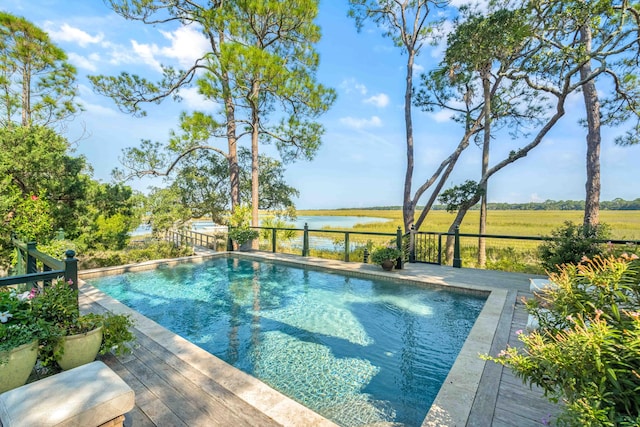 view of pool featuring a deck with water view