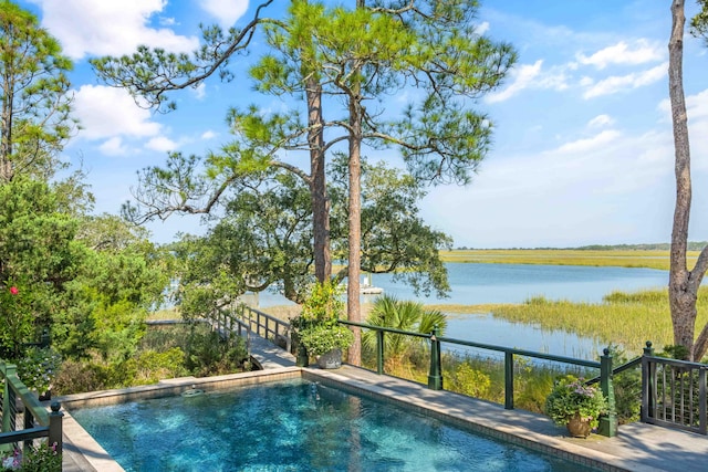 view of pool with a water view