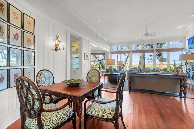 dining area featuring hardwood / wood-style flooring, ornamental molding, and ceiling fan