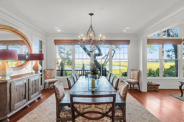 dining space featuring ornamental molding, a wealth of natural light, and light wood-type flooring