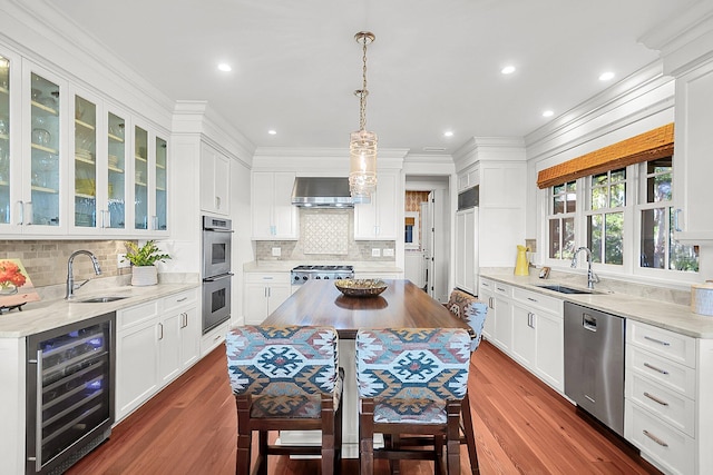 kitchen featuring wine cooler, stainless steel appliances, sink, and wall chimney range hood