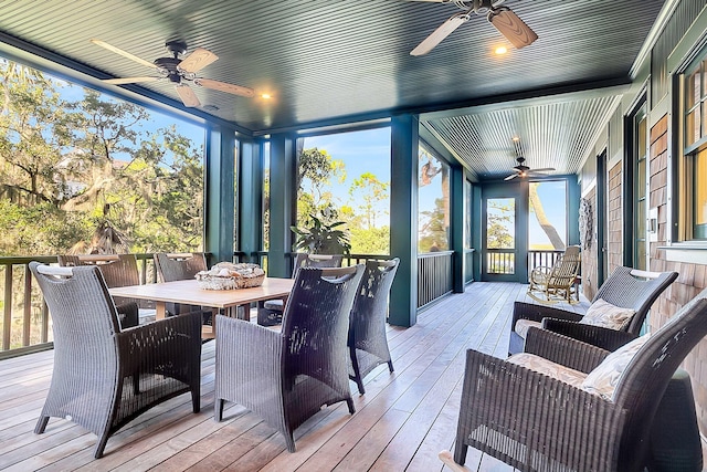 sunroom / solarium featuring ceiling fan