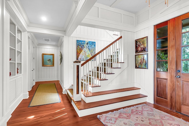 foyer featuring crown molding and dark hardwood / wood-style flooring