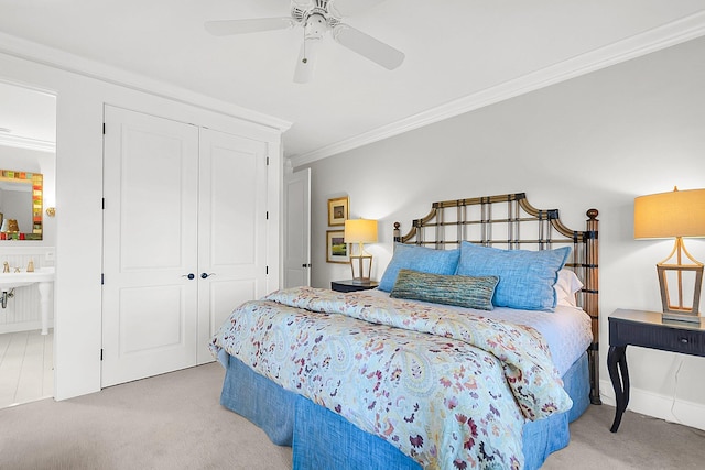 bedroom featuring a closet, ornamental molding, and light carpet