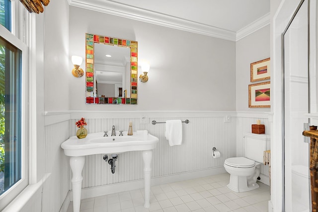 bathroom with tile patterned flooring, crown molding, and toilet