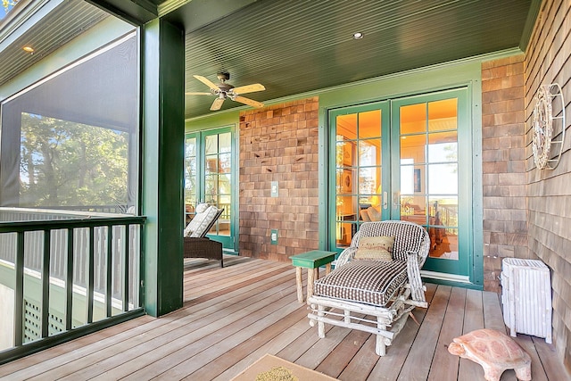 sunroom with radiator, french doors, and ceiling fan