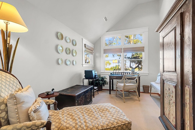 carpeted home office with lofted ceiling