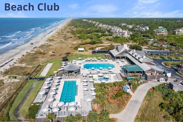 birds eye view of property with a water view and a beach view