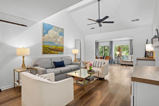 living room featuring high vaulted ceiling, hardwood / wood-style flooring, and ceiling fan