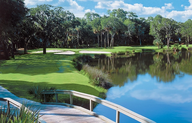 view of property's community with a water view and a yard