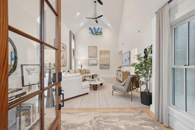 living room featuring french doors, visible vents, high vaulted ceiling, and wood finished floors