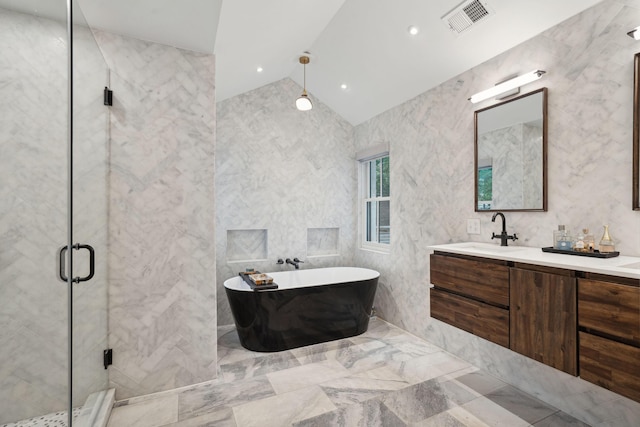 full bathroom featuring visible vents, a shower stall, double vanity, a sink, and a freestanding bath