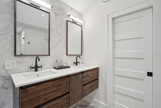 full bath featuring double vanity and a sink