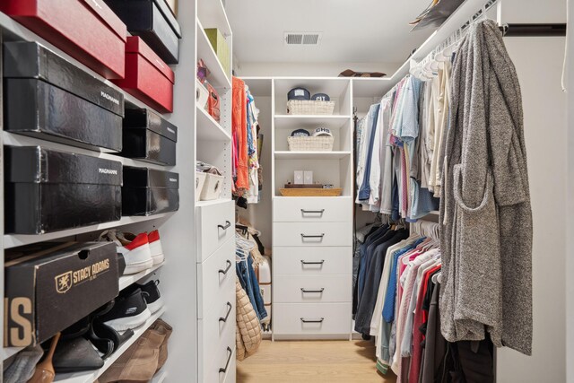 walk in closet with light wood-style flooring and visible vents