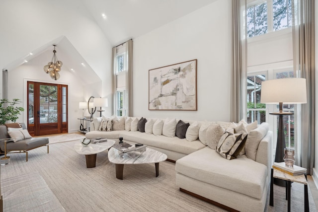 living area featuring high vaulted ceiling and a notable chandelier