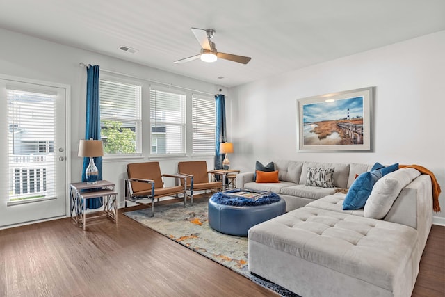 living room with ceiling fan and dark hardwood / wood-style flooring