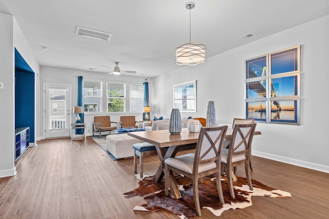 dining area featuring hardwood / wood-style floors and ceiling fan