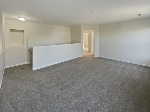 empty room featuring dark carpet