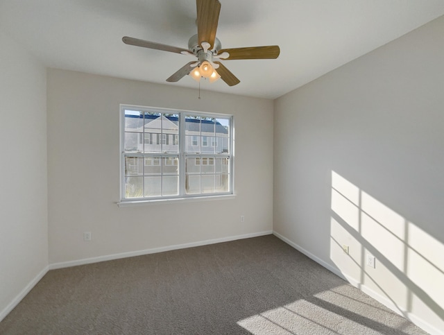 spare room featuring ceiling fan and carpet